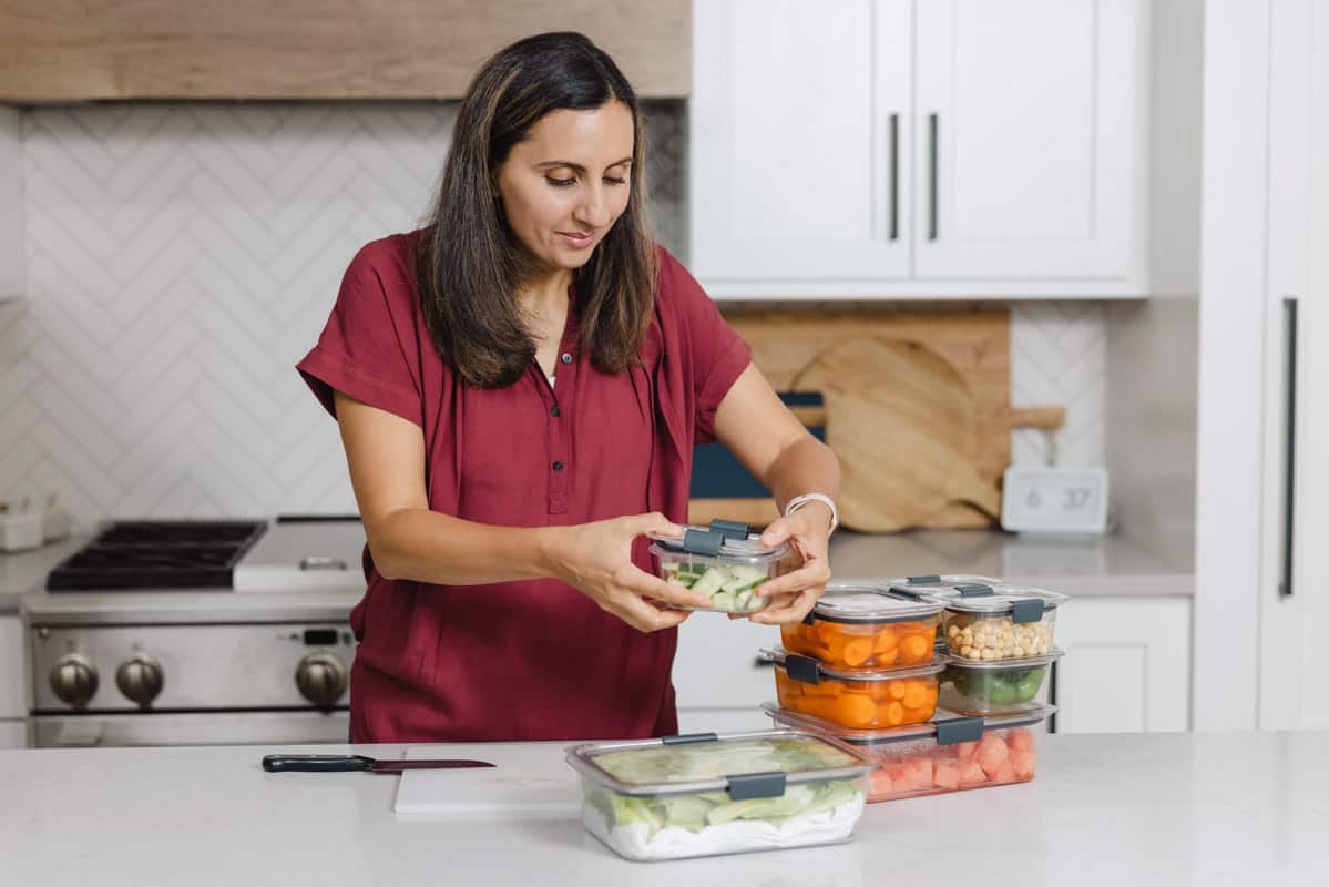 Preparing fruits and vegetables into meal prep containers